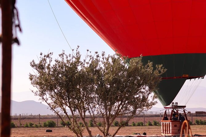Marrakech Private Balloon Ride with Breakfast - Preparing the Moroccan flag-adorned balloon